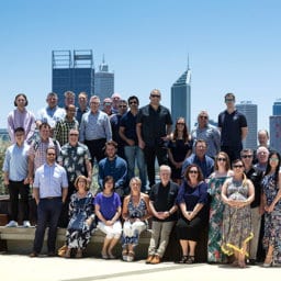 HFM team group photo for the Christmas party in 2018 with Perth City and the Swan river in the background